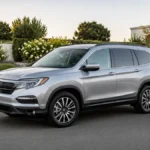 Used Honda Pilot parked on a suburban road for reliability and cost-to-own guide